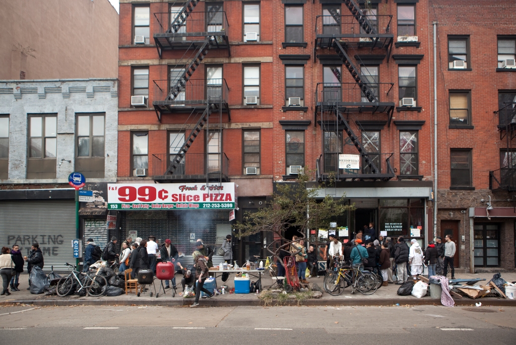 Local residents barbecue food on the street in New York City.