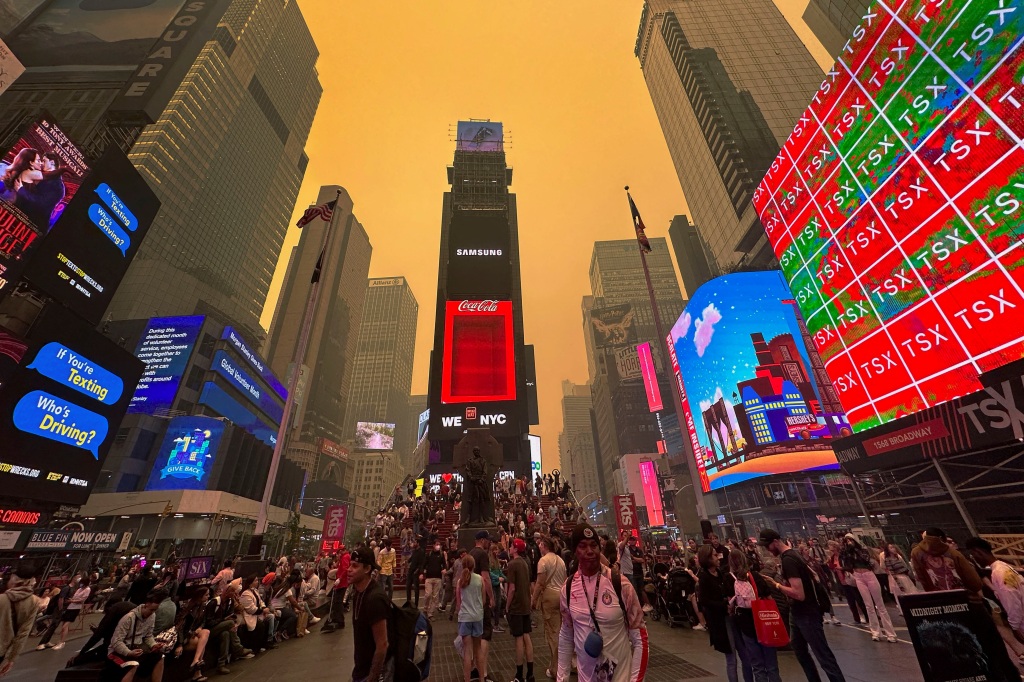 Times Square takes on an eerie orange glow in the wake of the wildfires in Canada.