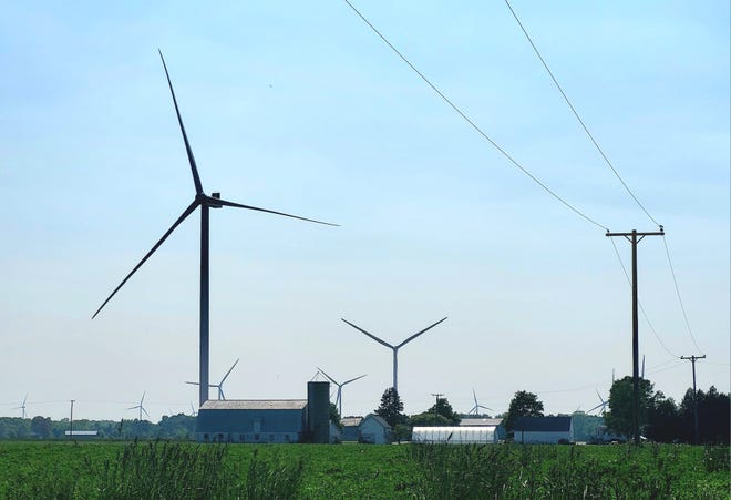Wind turbines spin on farmland Tuesday, May 30, 2023 in Huron Township.